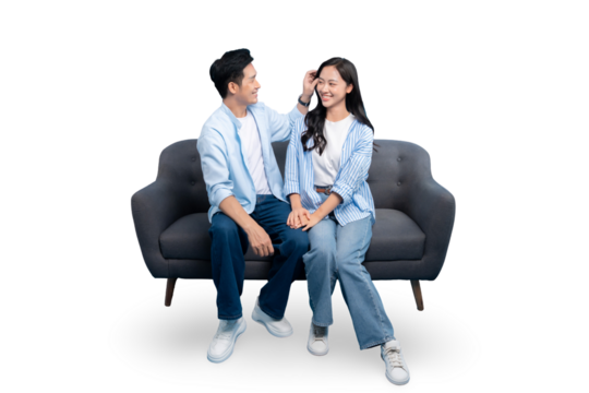 A happy couple sitting on a sofa together. This photo captures a beautiful moment of tenderness and affection on PNG background