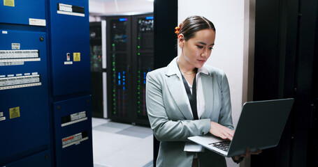 Laptop, typing and woman in server room for administration, network maintenance or programming....
