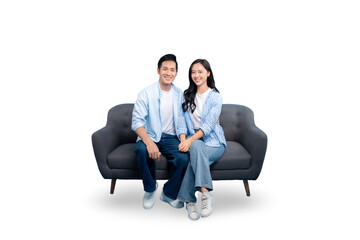 A happy couple sitting on a sofa, smiling at the camera on PNG background