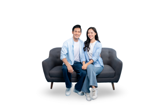 A happy couple sitting on a sofa, smiling at the camera on PNG background