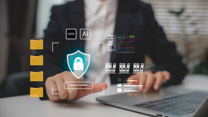 Businessman using laptop with virtual interface showing AI, data folders, and cyber security shield. Concept of data protection, cloud storage, business technology, and information safety.