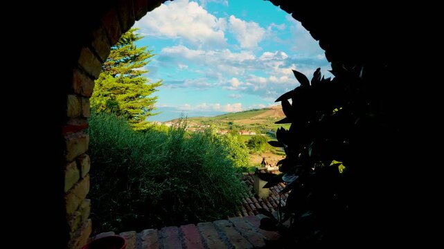 Forward moving shot from window of old farmhouse in Pineto with view of Abruzzo hills