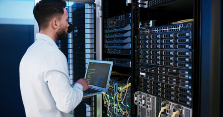Man, laptop and typing for programming in server room, hardware and inspection for IT solution at...