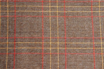 A detailed close-up of a brown plaid fabric, perfect for backgrounds and textures.