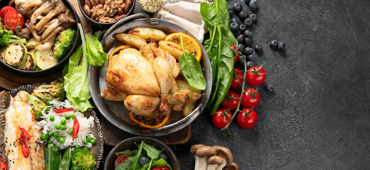 Table scene of various delicious foods. Healthy, family dinner.