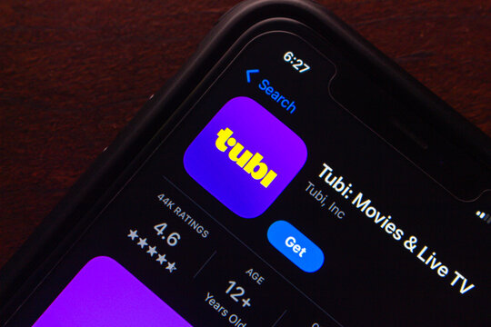 Mexico City, MEXICO - Aug 14 2025 : Close-up of the Tubi app download page on a smartphone, showing ratings, age limit, and install button in dark mode.