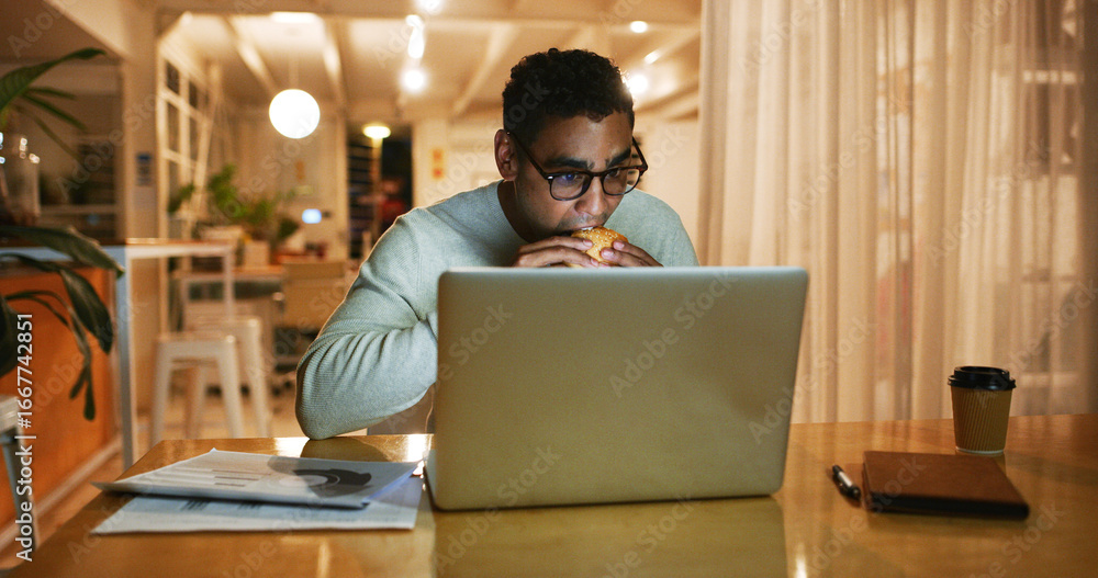Poster eating, laptop and night with web designer man in office for overtime work on coding or programming.