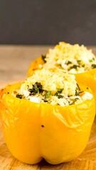 Two yellow bell peppers stuffed with a savory mixture