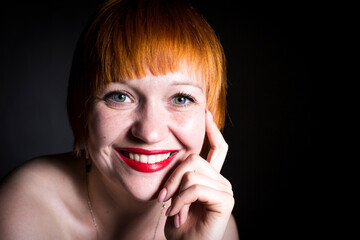 moscow, russia, 14.06.2017 A woman with red hair and a red lipstick is smiling