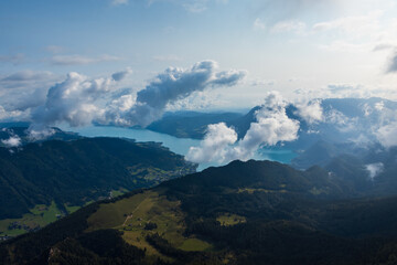Aerial panoramic view to lake Attersee from mountain Schafberg with clouds. Austria landscape