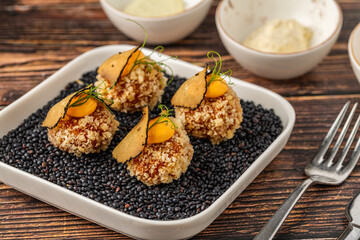 Gourmet quinoa balls with crispy texture and artistic garnish