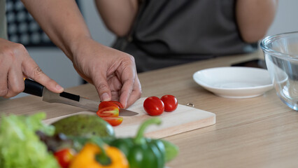 Healthy Cooking. Preparing fresh vegetables together in a modern kitchen.