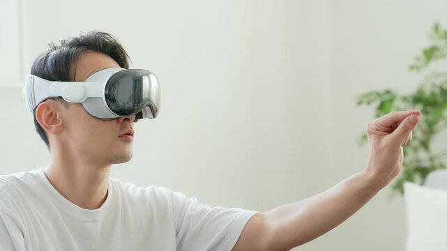 A man operating 3D images with VR goggles