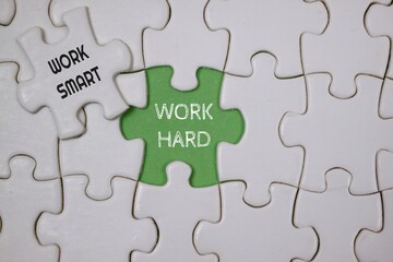 Fototapeta premium Conceptual Puzzle Representing Hard Work and Smart Work Techniques, highlighted in green and white puzzle