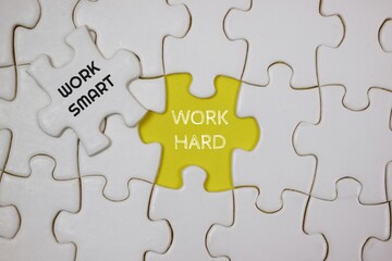 Fototapeta premium Conceptual Puzzle Representing Hard Work and Smart Work Techniques, highlighted in yellow and white puzzle