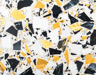 Fototapeta premium Overhead terrazzo stone surface with larger bold chips in contrasting black, white and soft gold, clean background