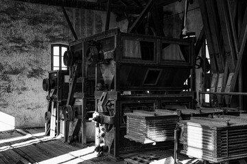 Old industrial machinery in a deserted factory during daylight