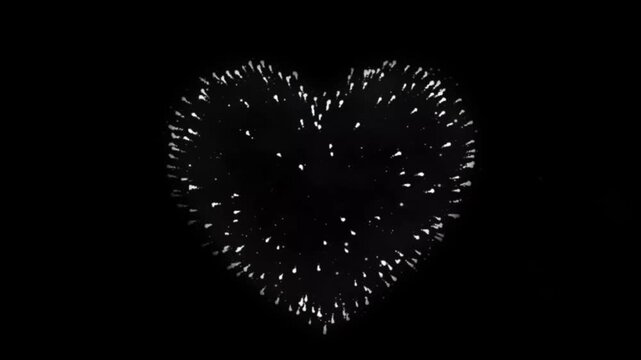 Realistic white firework heart shape on black background.