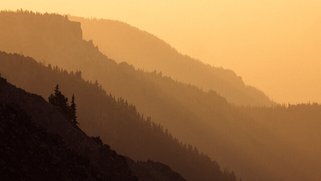 Tranquil scene of mountain range filled with rays of sunlight.