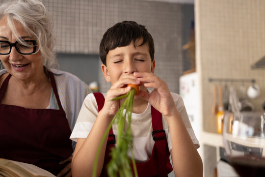 Mother and son cooking together in the kitchen sharing an experience