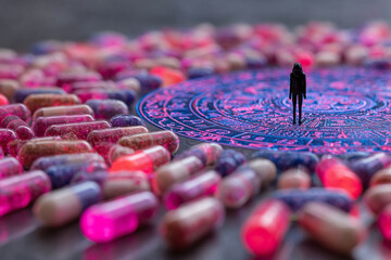 Miniature figure standing on glowing circuit board surrounded by colorful medical capsules
