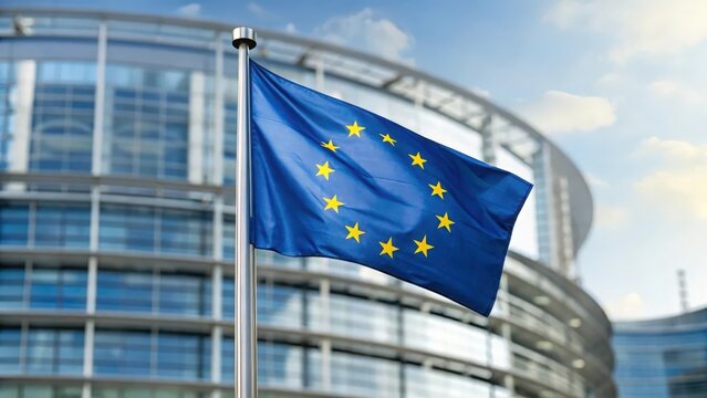 EU flag fluttering against European Parliament building — representing European cooperation and democracy