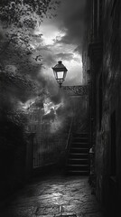 Black and white alleyway with stairs and lamp