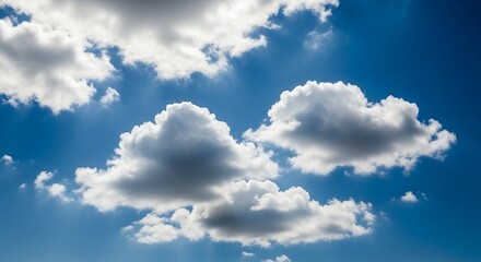 Fototapeta premium Fluffy White Clouds in a Bright Deep Blue Sky on a Clear Sunny Day