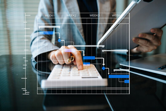 Project manager working and update tasks with milestones progress planning and Gantt chart scheduling diagram.business working at office