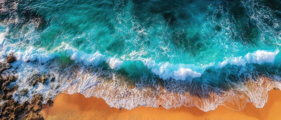 Aerial view of turquoise waves crashing on a sandy beach (4)