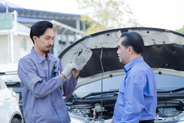 Garage small business or car insurance, Mechanic discussing auto repair details with customer,...