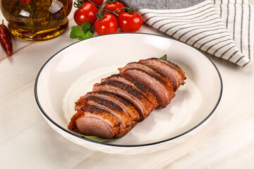 Sliced duck breast baked with cherry