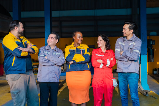 Team of mechanics stacking hands in unity at garage workshop, symbolizing cooperation, garage small business partnership, teamwork and professional collaboration for success in auto repair service