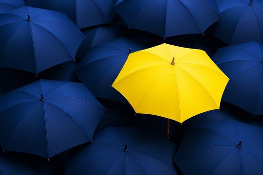 Bright yellow umbrella standing out among dark blue umbrellas on a seamless background, symbolizing individuality and uniqueness concept.