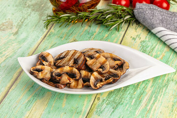 Tasty hot grilled champignon mushrooms
