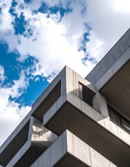 Fototapeta premium Modern Concrete Architecture Against Blue Sky with Dramatic Cloud Formations