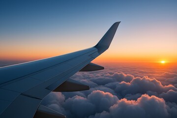 Fototapeta premium Airplane wing above clouds during golden hour with dramatic sunset light and soft cloudscape background viewed from passenger window seat. Ai generative
