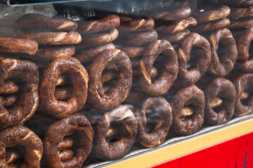Fresh Turkish simit bread rings displayed on a street vendor’s stall. Traditional cuisine, street food culture, authentic Turkish bakery.