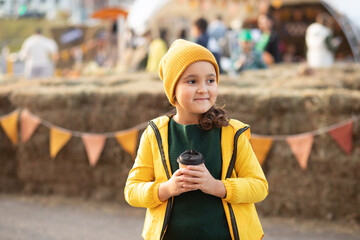 Cute little girl on autumn town festival