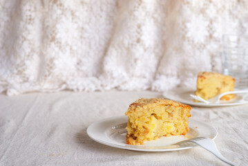 homemade apple streusel cake on white ceramic plate.