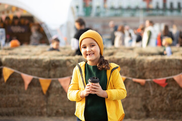Cute little girl on autumn town festival