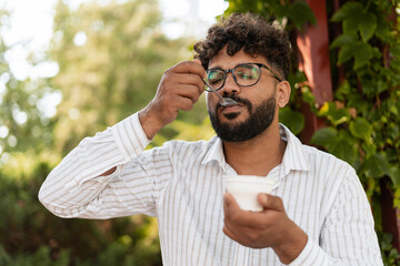 Office worker enjoying a healthy yogurt during lunch break in a park