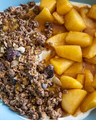 cozy autumn breakfast bowl greek yogurt granola caramelized apples close up