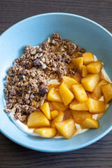 cozy autumn breakfast bowl greek yogurt granola caramelized apples close up