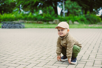 Fototapeta premium A Happy Toddler Playing Outdoors Joyfully in a Beautiful Park Setting A Truly Memorable and Joyful Moment Captured for Posterity, Showcasing the Wonders of Childhood and Exploration