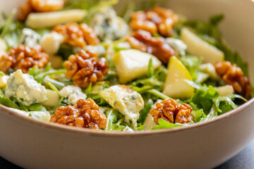 healthy fall salad with arugula pear cheese and candied walnuts