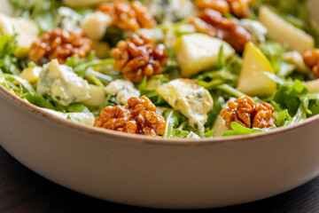healthy fall salad with arugula pear cheese and candied walnuts