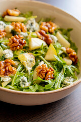 healthy fall salad with arugula pear cheese and candied walnuts