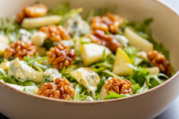 healthy fall salad with arugula pear cheese and candied walnuts