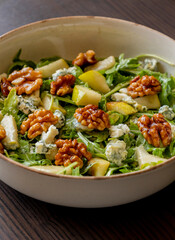 healthy fall salad with arugula pear cheese and candied walnuts